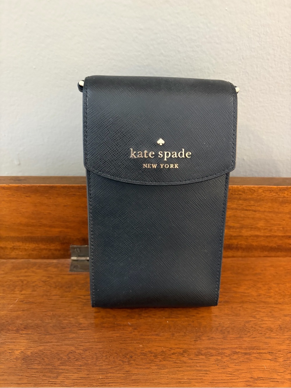 kate spade black saffiano leather phone pouch with gold logo